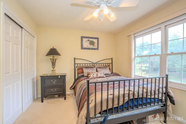 a bedroom with a bed and a large window