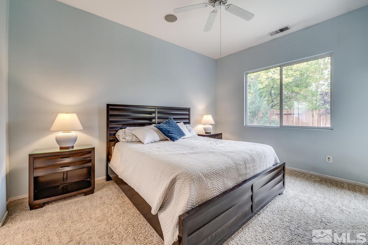 10645 Blue Moon Court Reno, NV 89521 - Photo 17 of 33 a bedroom with bed and a chandelier