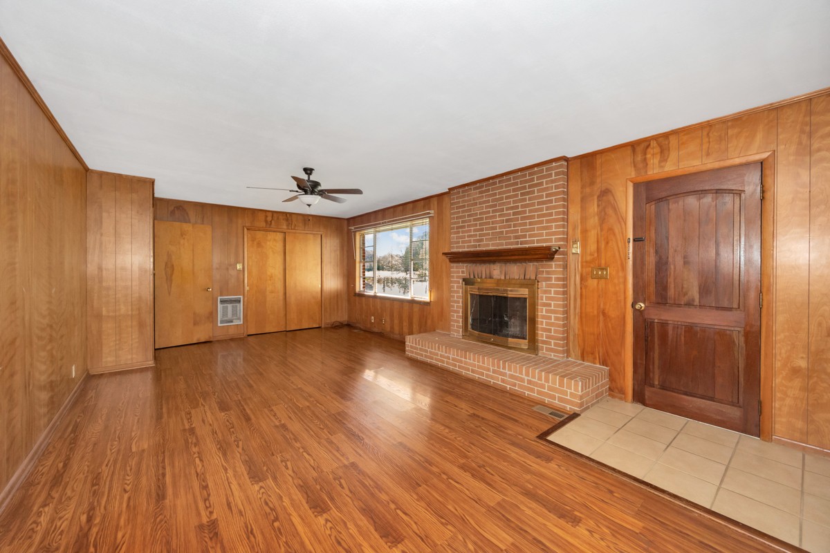 40 Blanche Road Taft, TN 38488 - Photo 12 of 38 an empty room with wooden floor fireplace and windows