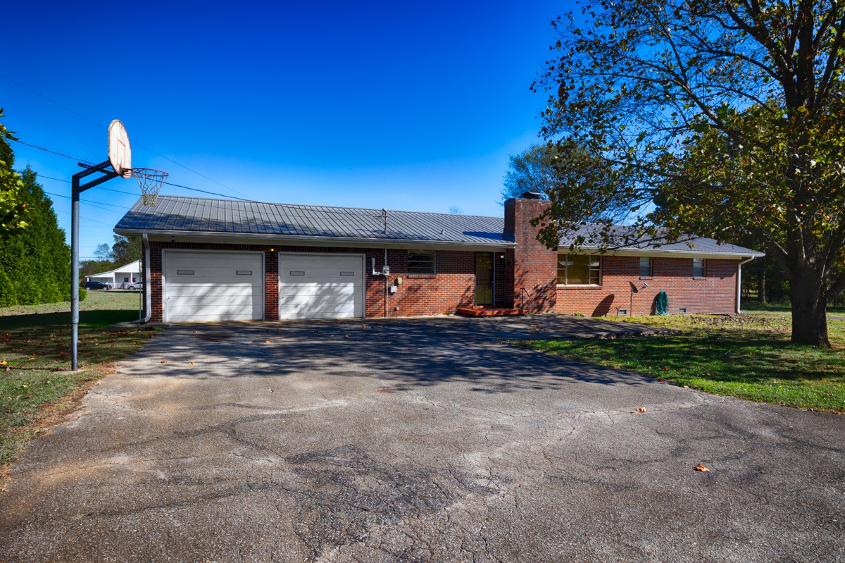 40 Blanche Road Taft, TN 38488 - Photo 29 of 38 a front view of a house with a yard and garage