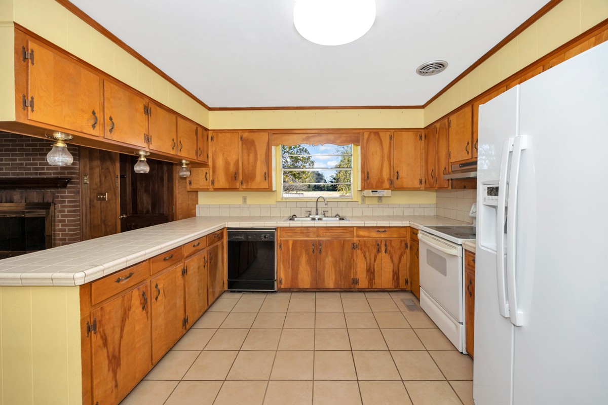40 Blanche Road Taft, TN 38488 - Photo 8 of 38 a kitchen with a sink a stove top oven cabinets and a refrigerator