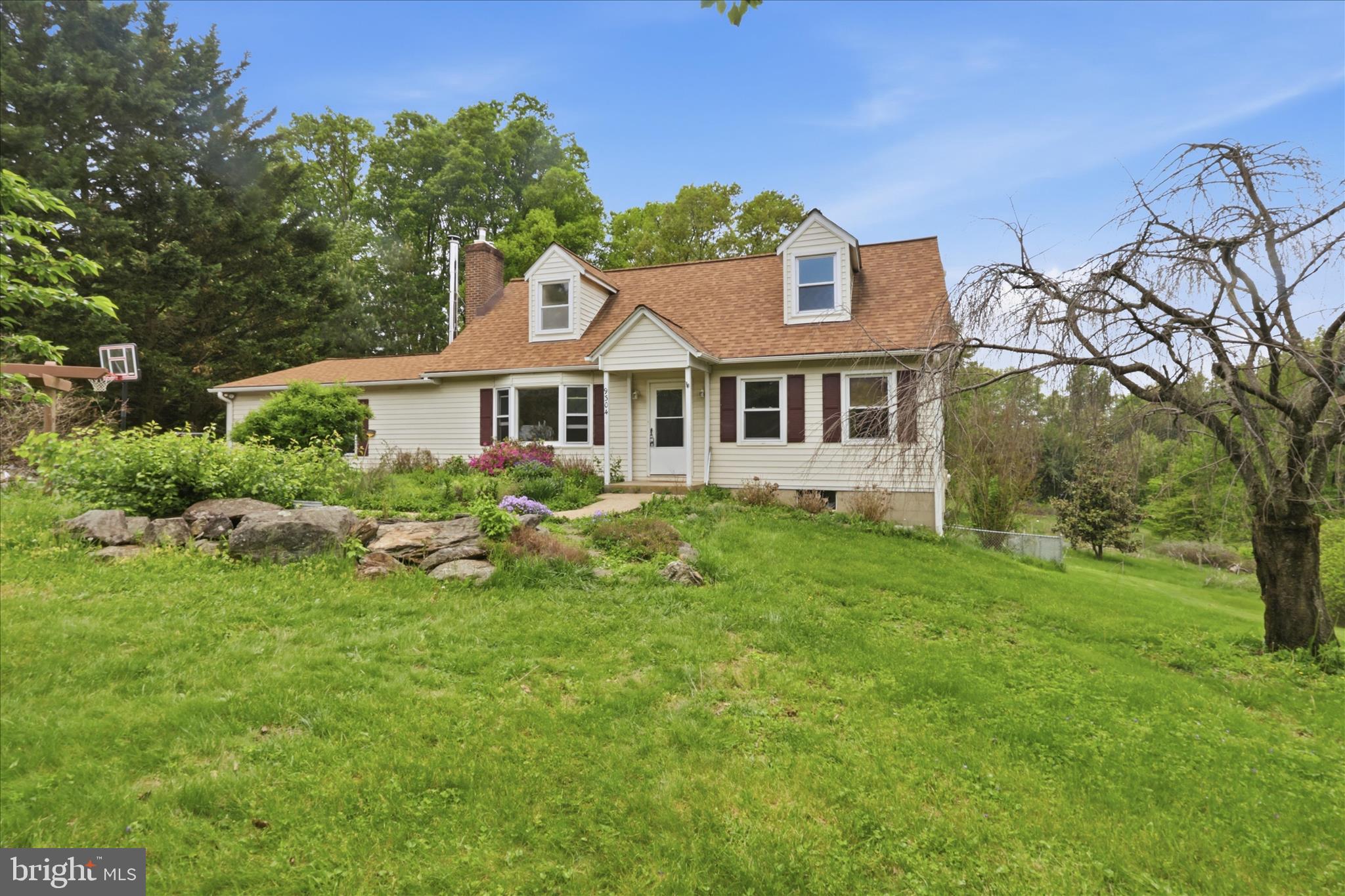 9304 Liberty Court Frederick, MD 21701 - Photo 11 of 49 a front view of a house with a garden and trees