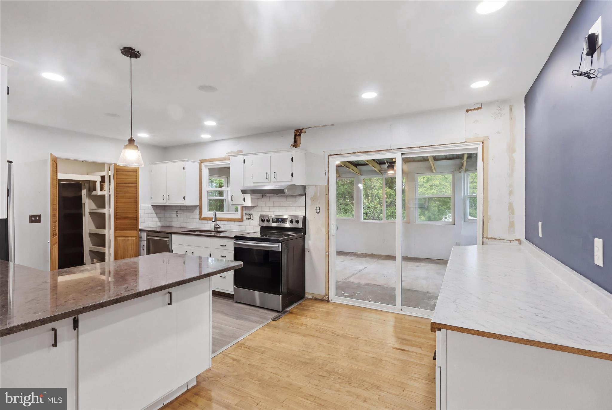 9304 Liberty Court Frederick, MD 21701 - Photo 19 of 49 a large kitchen with kitchen island a large window a sink and stainless steel appliances