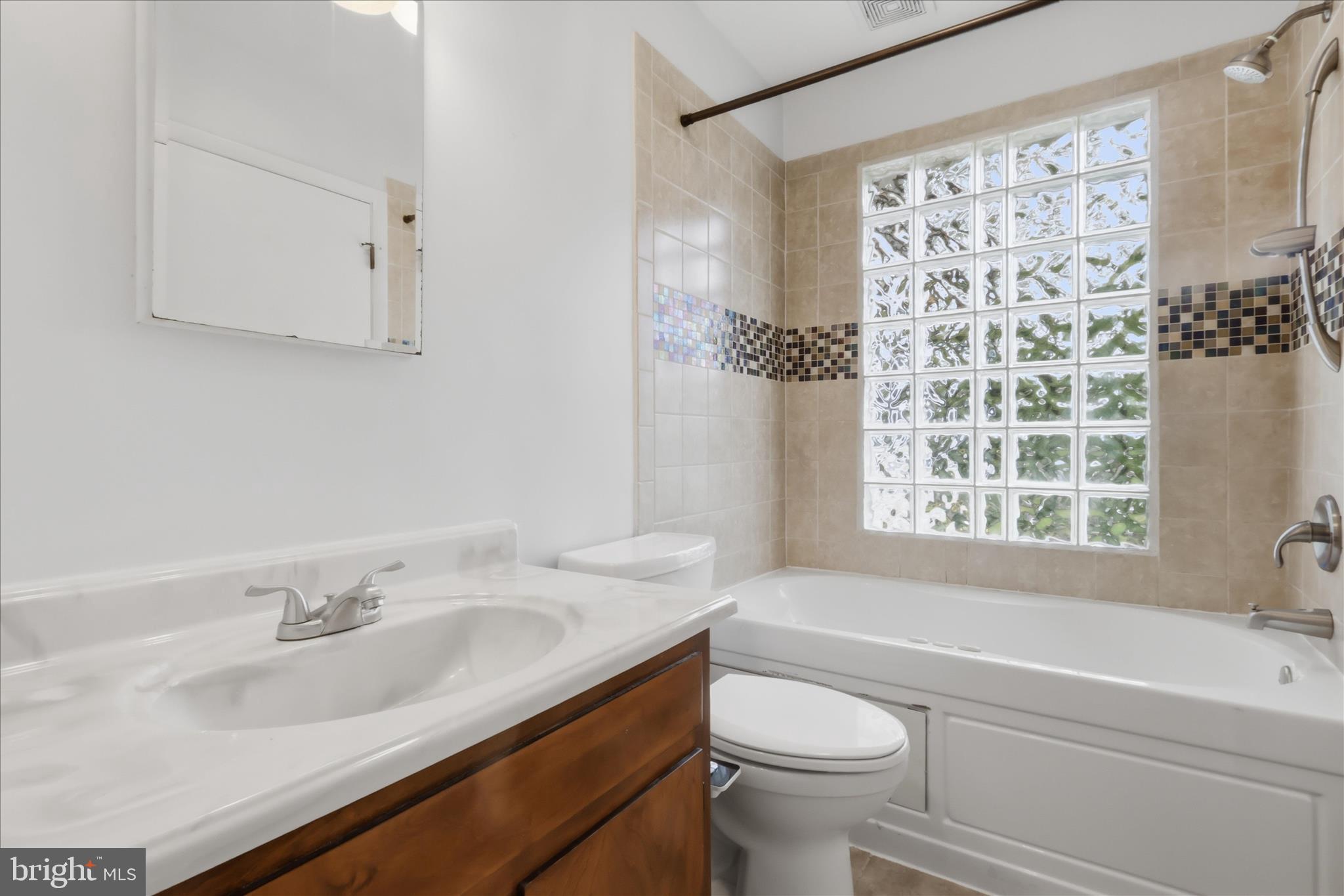9304 Liberty Court Frederick, MD 21701 - Photo 25 of 49 a bathroom with a sink toilet a mirror and shower