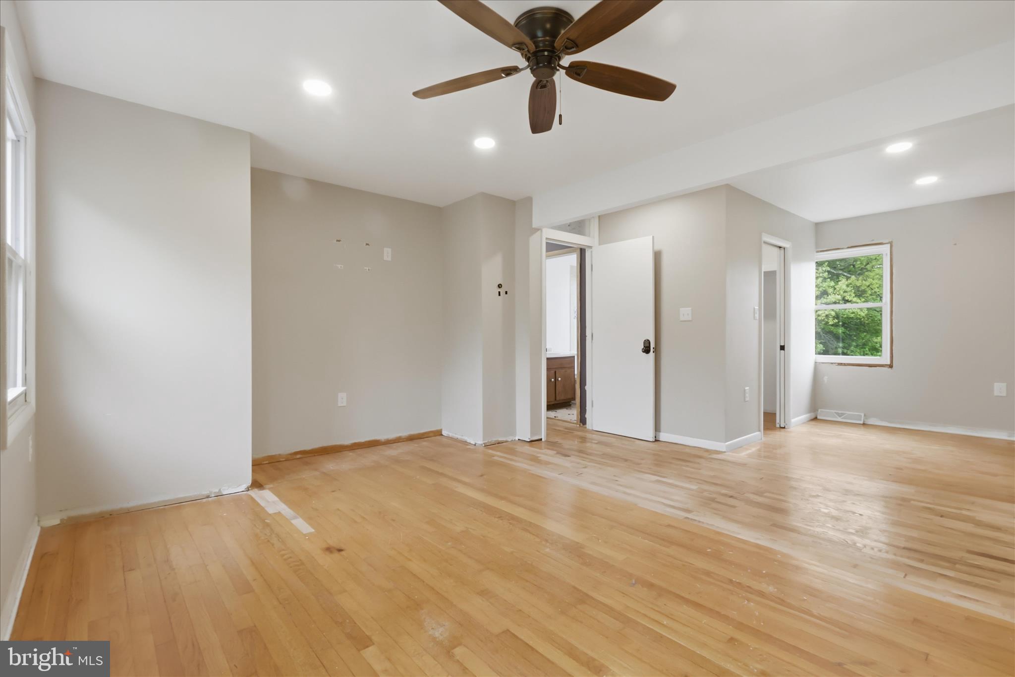 9304 Liberty Court Frederick, MD 21701 - Photo 28 of 49 a view of an empty room with window and wooden floor
