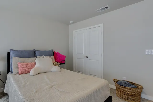 a bedroom with a bed and a couch