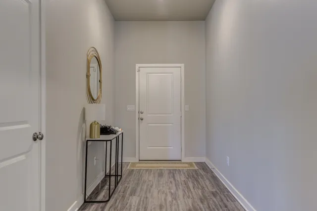 a view of a room with wooden floor and white walls