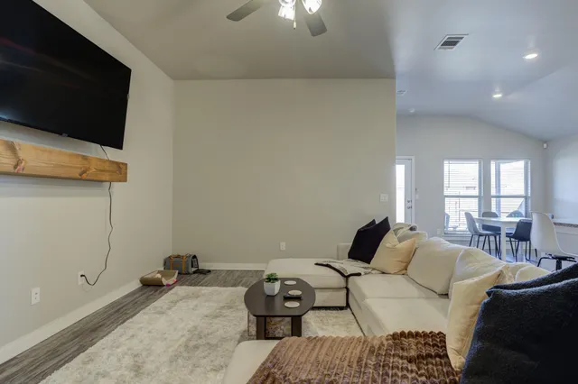 a bedroom with a bed and flat tv screen