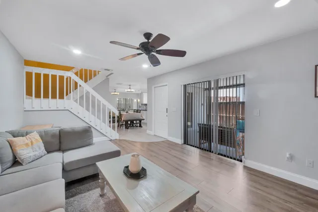 a living room with furniture and a wooden floor