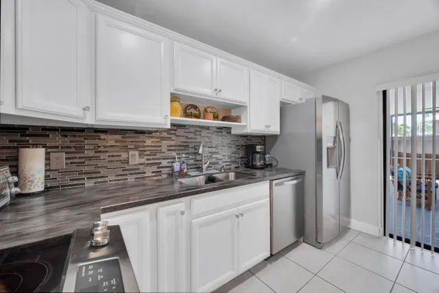 a utility room with sink dryer and washer
