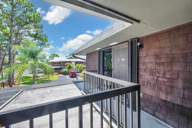 a view of balcony with furniture and garden