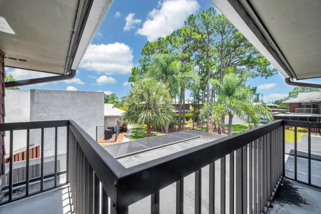 a view of a balcony with a potted plant