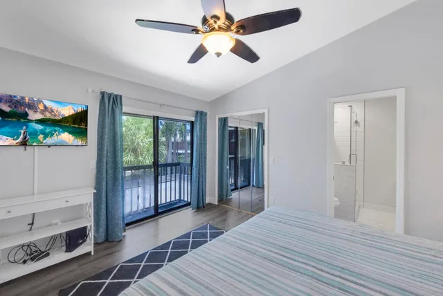 a view of a hallway with wooden floor and furniture