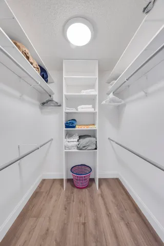 a bedroom with a bed and a ceiling fan