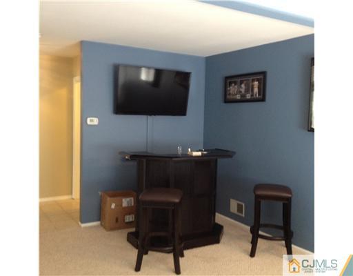 2 Overview Court Edison, NJ 08817 - Photo 8 of 25 a living room with furniture and a flat screen tv