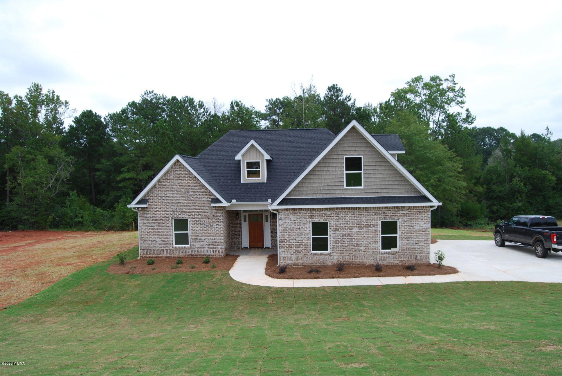 a view of a house with a yard and porch