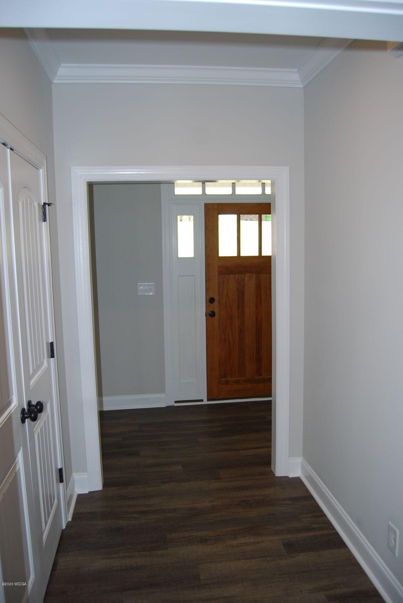 65 Carters Way Forsyth, GA 31029 - Photo 2 of 13 a view of an empty room with wooden floor