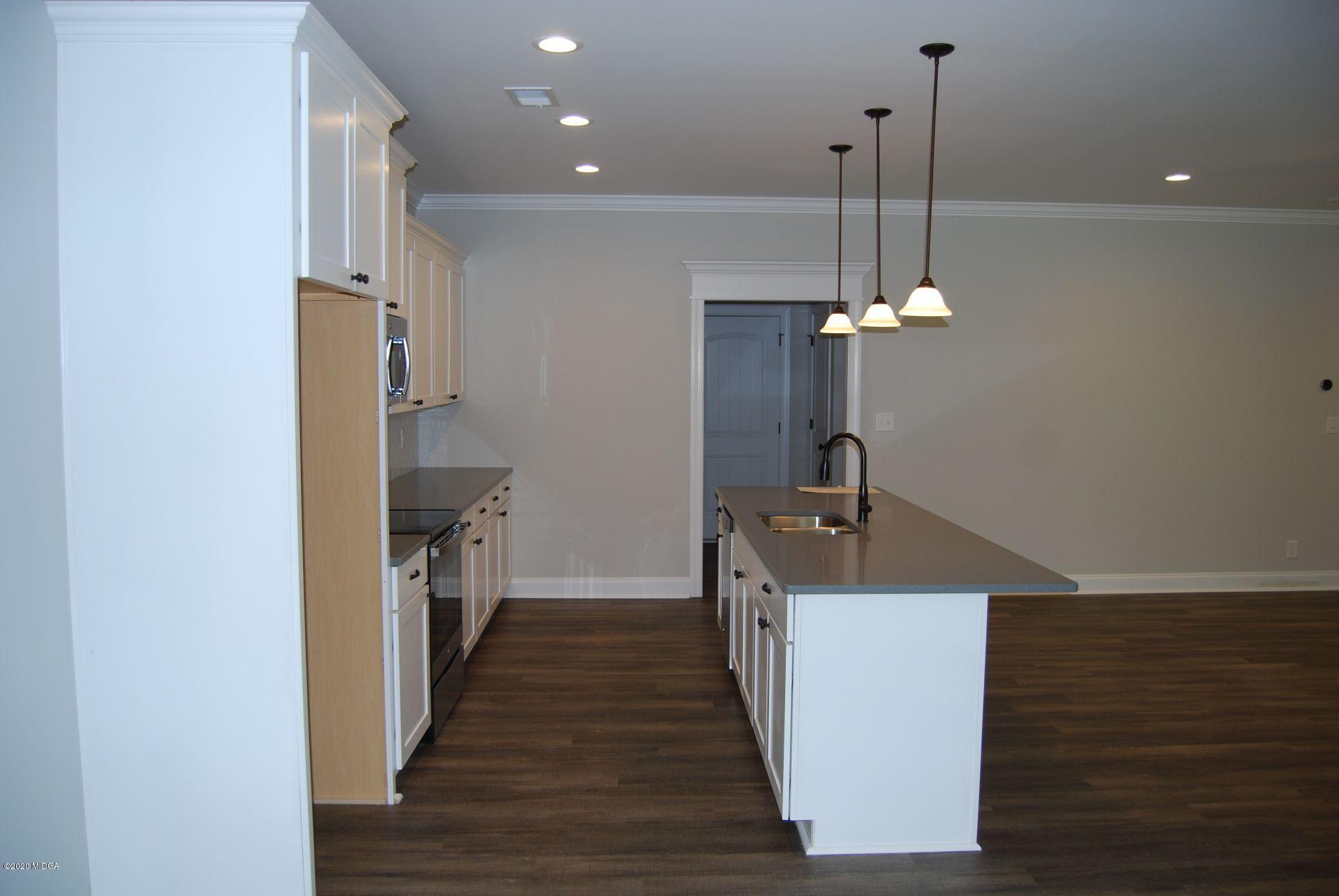 65 Carters Way Forsyth, GA 31029 - Photo 4 of 13 a very nice looking room with a wooden floor