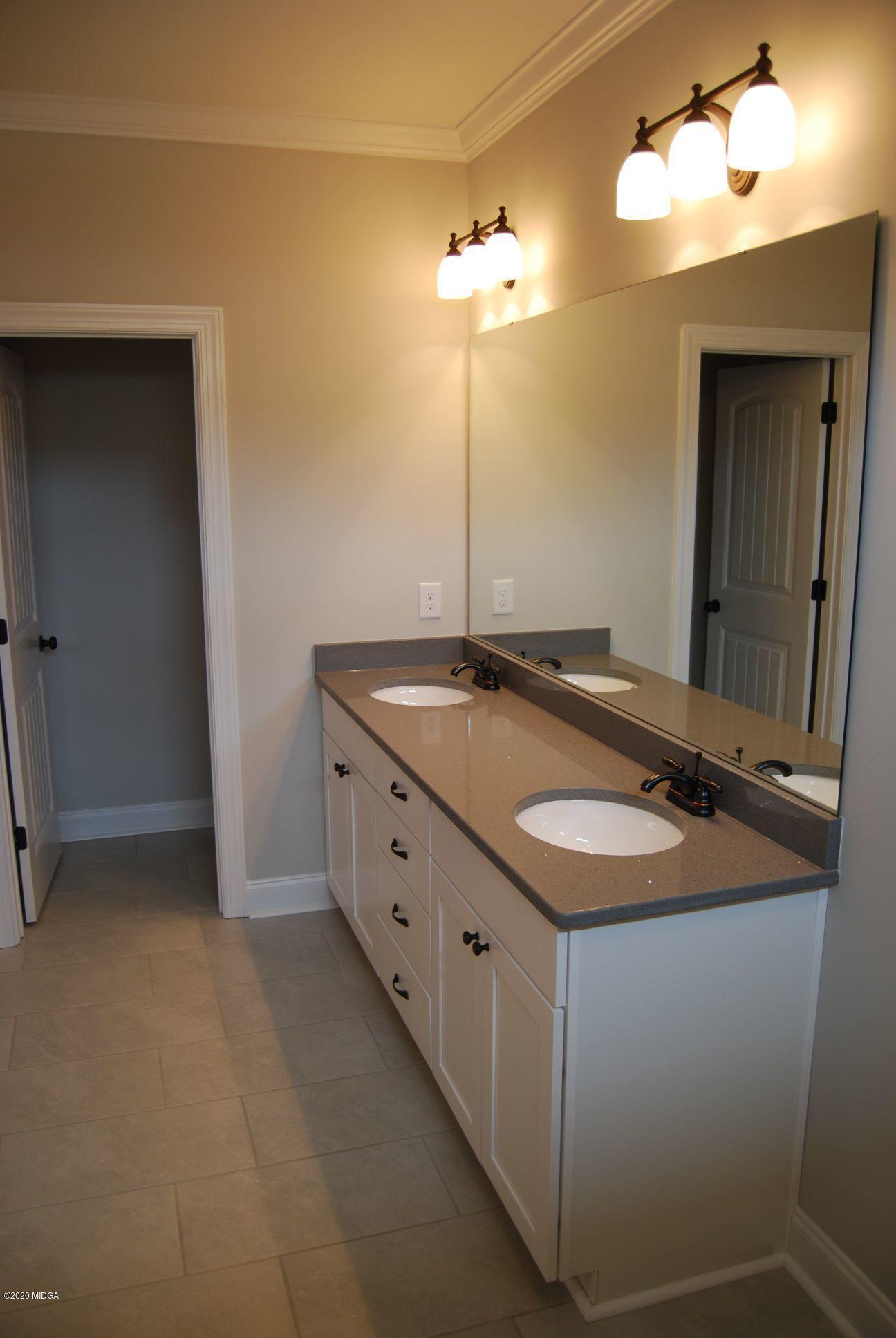 65 Carters Way Forsyth, GA 31029 - Photo 7 of 13 a bathroom with a sink and a mirror
