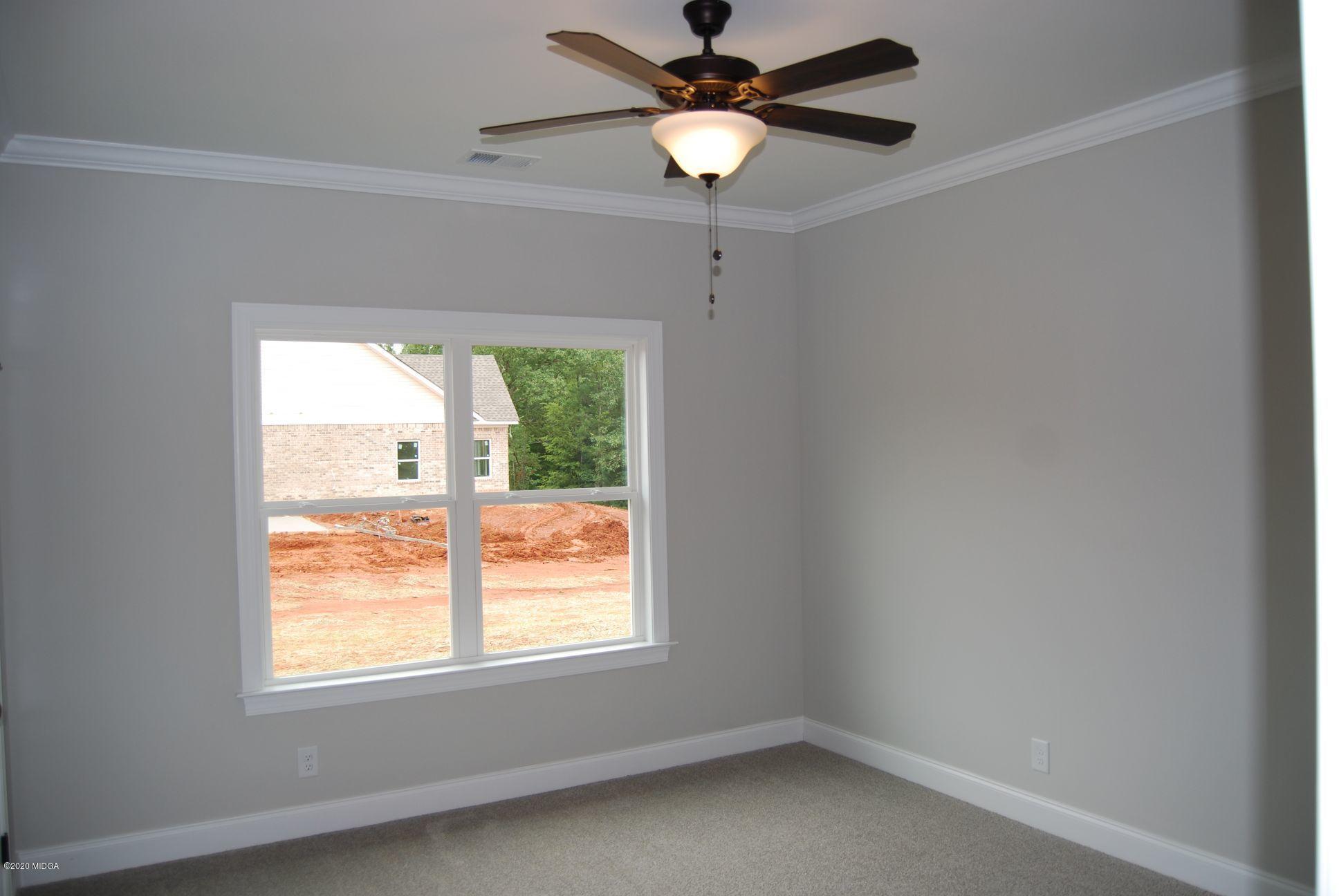 65 Carters Way Forsyth, GA 31029 - Photo 9 of 13 an empty room with a window and a fan