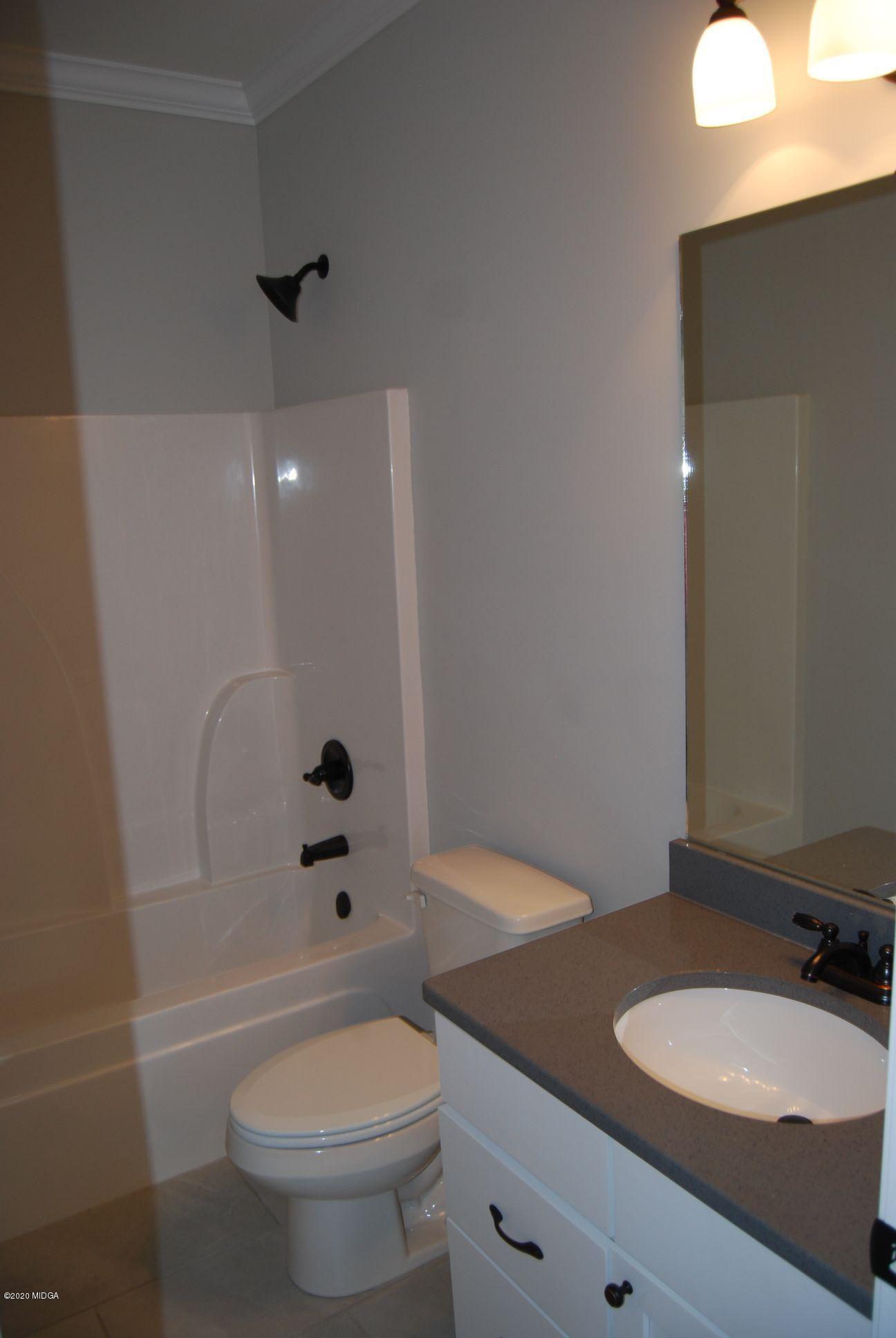 65 Carters Way Forsyth, GA 31029 - Photo 10 of 13 a bathroom with a sink a toilet and shower