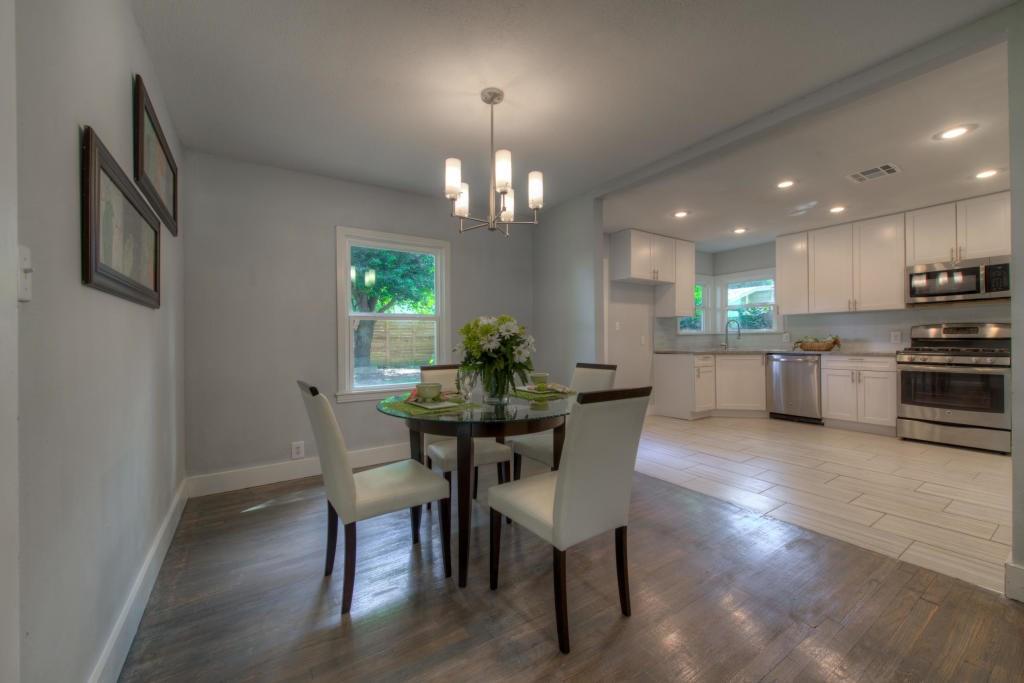 2011 Fort View Road Austin, TX 78704 - Photo 16 of 28 Hardwood flooring flows seamlessly from the dedicated dining area into the open-concept kitchen.