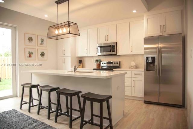 a kitchen with stainless steel appliances granite countertop a refrigerator a stove a microwave oven a sink and dishwasher with wooden floor