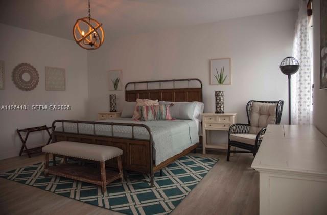 15105 Southwest 180th Street Miami, FL 33187 - Photo 13 of 21 a bedroom with a bed and a chandelier