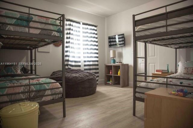 15105 Southwest 180th Street Miami, FL 33187 - Photo 16 of 21 a bedroom with furniture and a large window