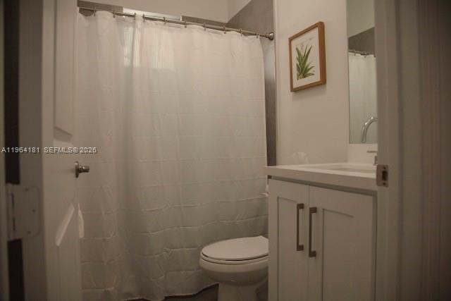 15105 Southwest 180th Street Miami, FL 33187 - Photo 19 of 21 a bathroom with a shower curtain and a toilet