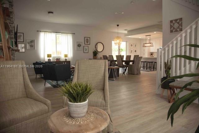 15105 Southwest 180th Street Miami, FL 33187 - Photo 7 of 21 a living room with furniture a dining table and a potted plant