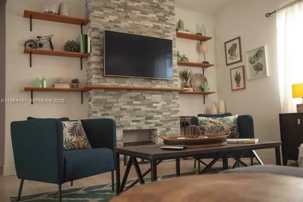 a living room with furniture and a flat screen tv