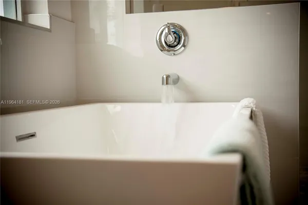 a bath tub sitting next to a white wall