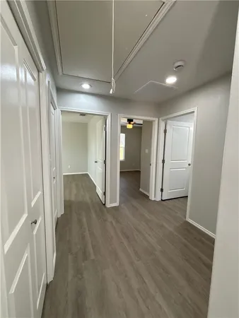 a view of a hallway with wooden floor