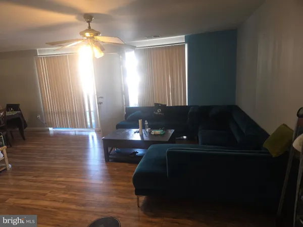 a living room with furniture and a lamp