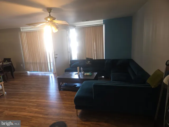 a living room with furniture and a lamp