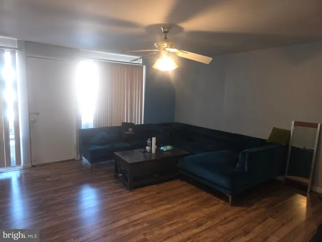 a living room with couch and wooden floor