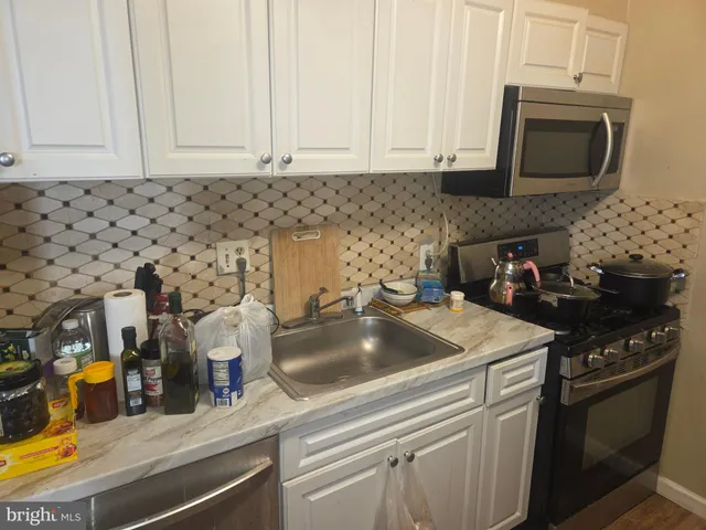 a kitchen with a sink stove and cabinets