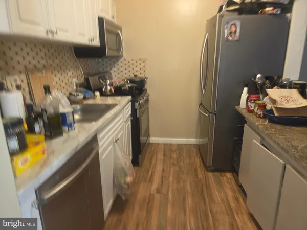 a kitchen with a sink and a refrigerator