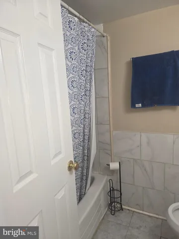 a bathroom with a shower and a sink