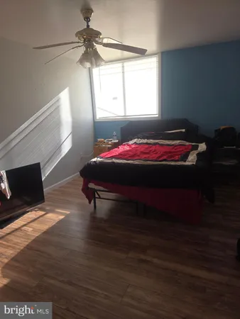 a room with a bed window and flat screen tv
