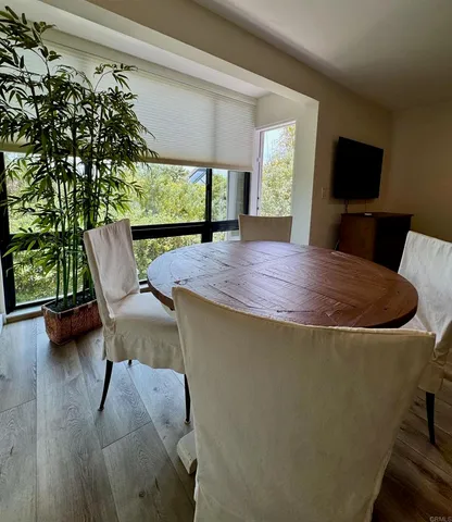 a view of a dining room with furniture window and wooden floor