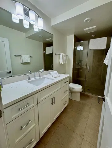 a bathroom with a double vanity sink mirror and toilet