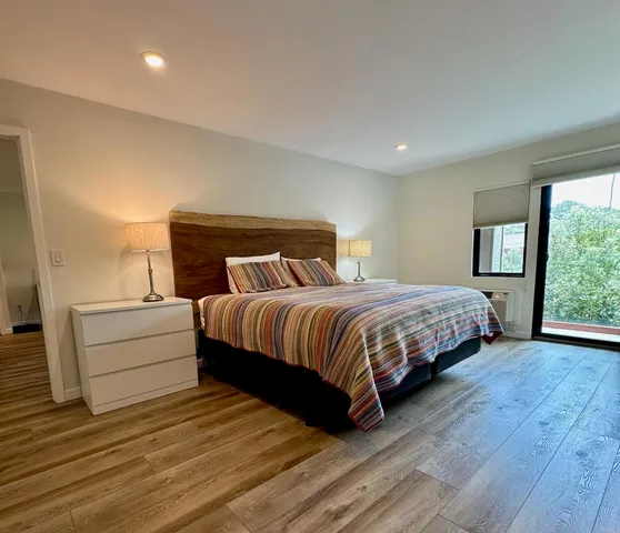 a bedroom with a bed and window