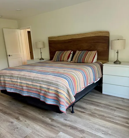 a bedroom with a bed and a mirror