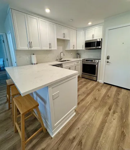 a kitchen with a stove a sink and a microwave