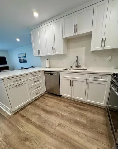 a large kitchen with cabinets and stainless steel appliances