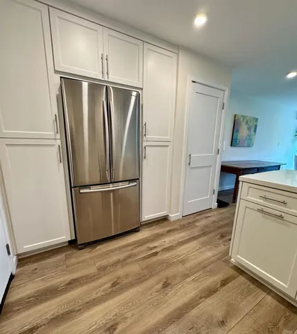 a kitchen with a refrigerator and a stove top oven