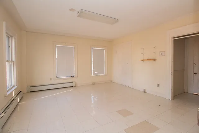 an empty room with a empty space and windows