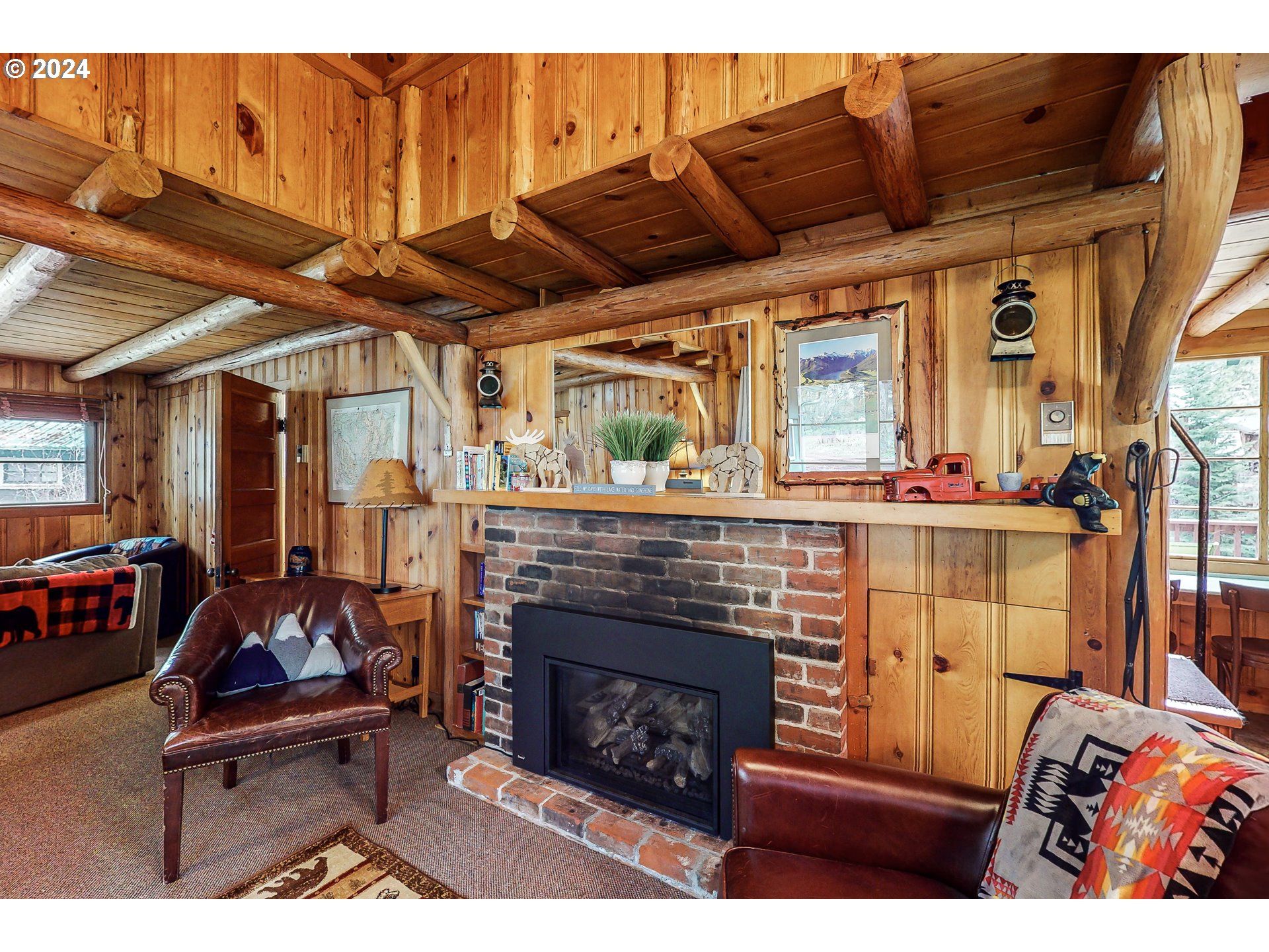 59975 Pollock Road Joseph, OR 97846 - Photo 12 of 34 a living room with furniture a flat screen tv and a fireplace